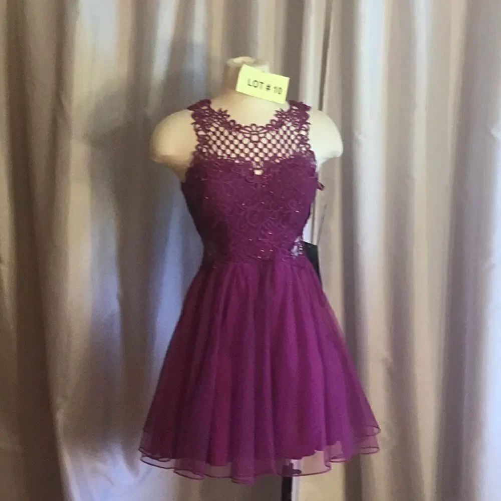 Cocktail/party dress with lace cutouts at neck & sides in plum purple size 5